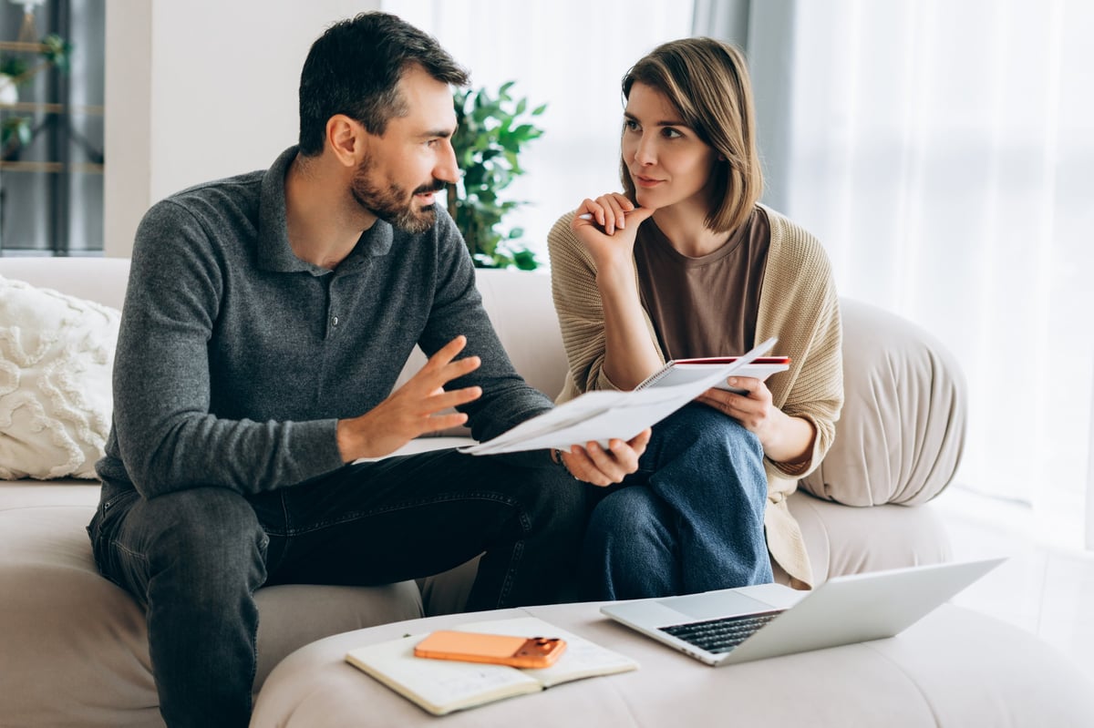 Adults planning their household budget together at home